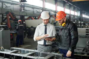 Two men wearing hard hats in Manufacturing plant