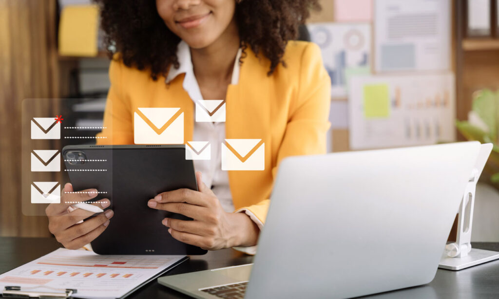 Happy business woman checking email on a tablet